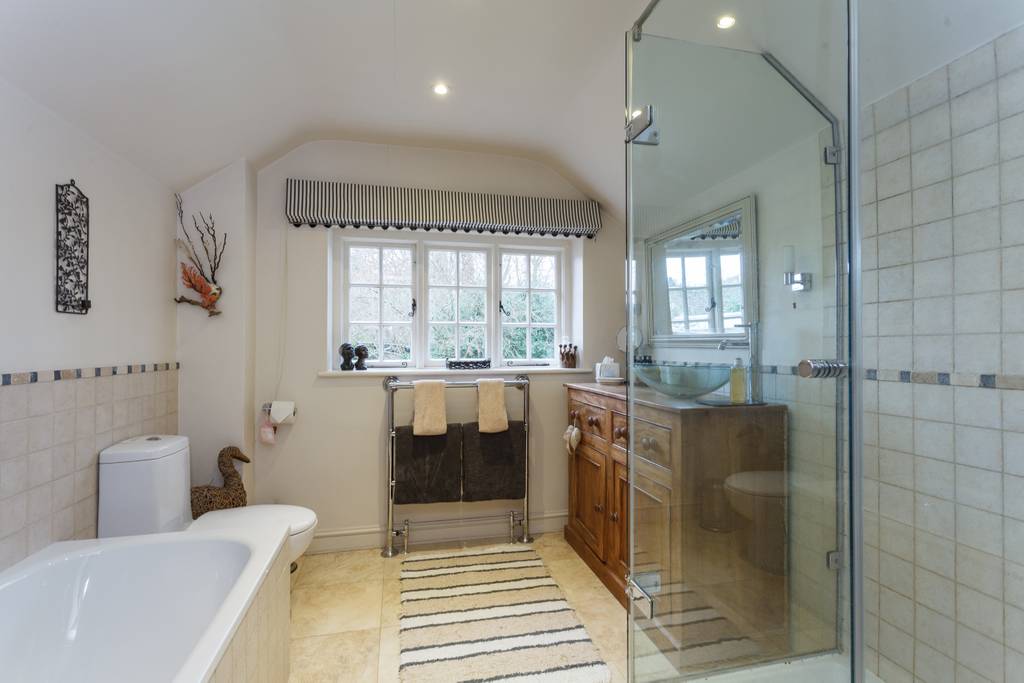 En-suite bathroom with freestanding bath and glass shower