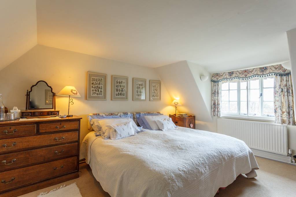 Twin bedroom with blue walls and garden views